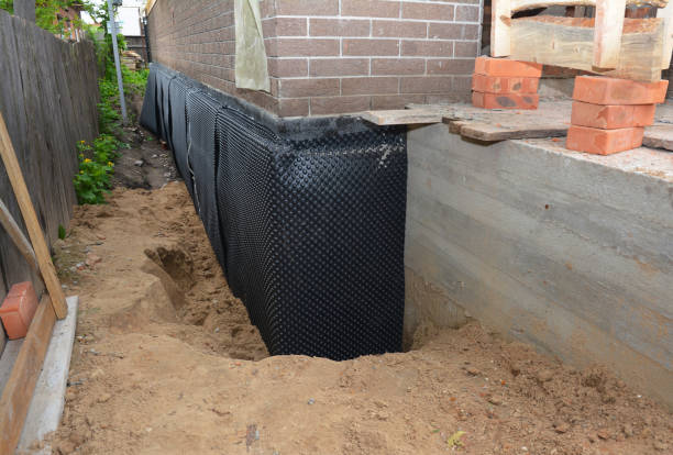 Happy homeowners after waterproofing job in Macy